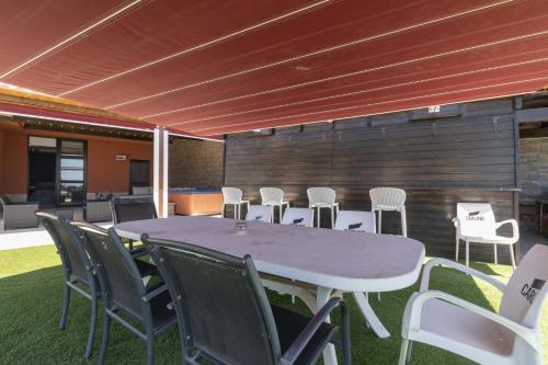 a white table and chairs on a patio at The Stables in Arona