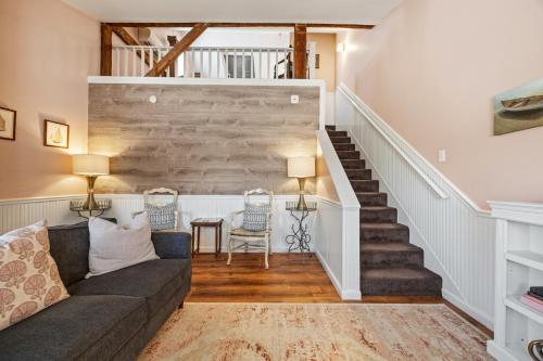 a living room with a couch and stairs at Hartstone Inn in Camden
