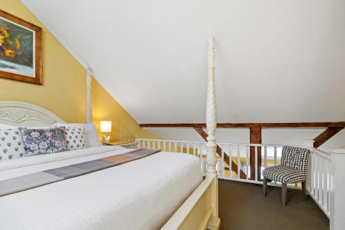 a bedroom with a bed and a balcony at Hartstone Inn in Camden