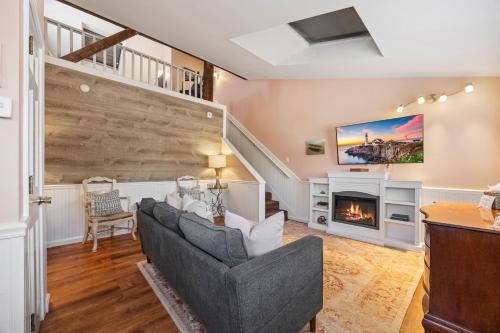 a living room with a couch and a fireplace at Hartstone Inn in Camden