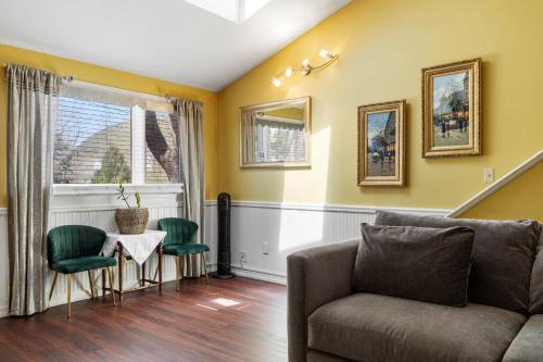 a living room with a couch and a table and chairs at Hartstone Inn in Camden