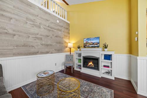 a living room with a fireplace and yellow walls at Hartstone Inn in Camden