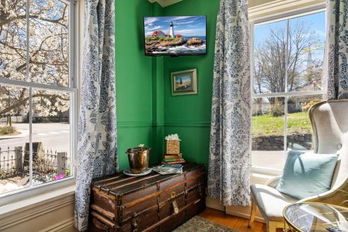 a living room with green walls and a window at Hartstone Inn in Camden