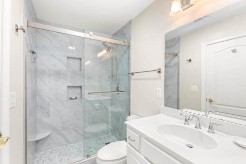 a bathroom with a shower and a sink and a toilet at Beach House 415 in Tybee Island