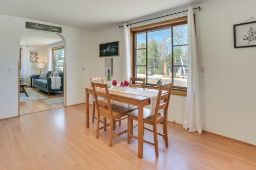 a kitchen and dining room with a table and chairs at 16 Mi to Sleeping Bear Dunes Cedar Home with Deck in Cedar