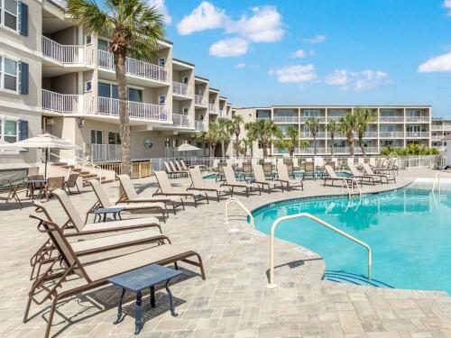 a swimming pool with lounge chairs and a resort at Atlantic Ocean 2 in Tybee Island