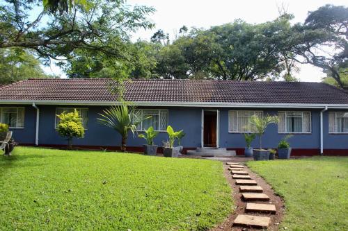 a blue house with a lawn in front of it at 2 bedroomed house with a lovely garden - 2177 in Umtali