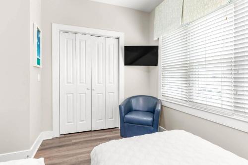 a bedroom with a blue chair and a bed at Atlantic Ocean 2 in Tybee Island