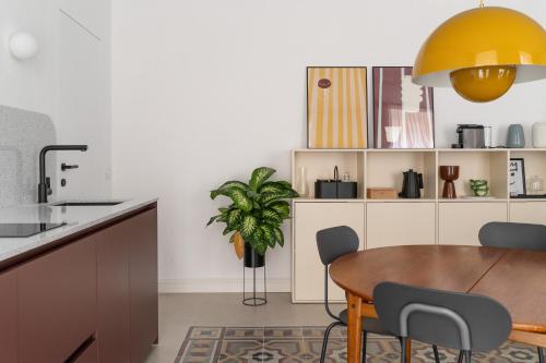 a kitchen with a wooden table and a yellow lamp at Casa Umbertina in La Spezia