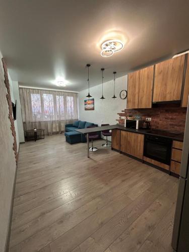 a living room with a blue couch and a table at ML Apartments in Odesa