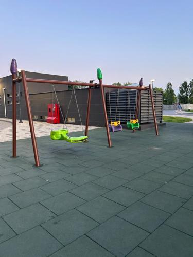 a group of swings in a parking lot at ML Apartments in Odesa