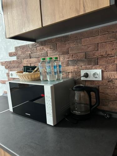 a microwave sitting on top of a kitchen counter at ML Apartments in Odesa