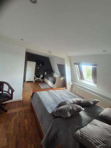 a bedroom with a bed with two pillows on it at B&B Panorama in Arnhem