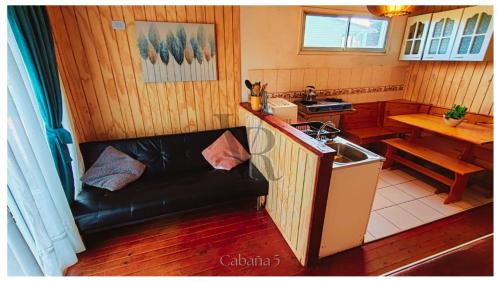 a kitchen with a couch and a sink in a room at Algarrobo playa Canelo Cabaña opción Tinaja in Algarrobo