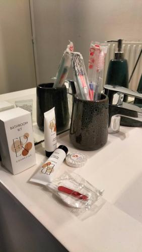 a bathroom counter with a counter top with a toothbrush and cosmetics at 2 bedrooms, air conditioning, garage, metro in Vaulx-en-Velin