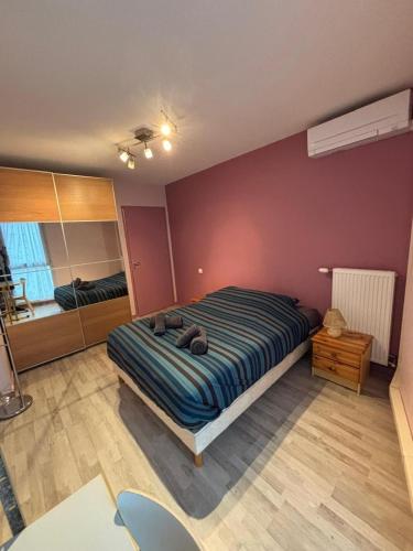 a bedroom with a bed and a mirror at 2 bedrooms, air conditioning, garage, metro in Vaulx-en-Velin