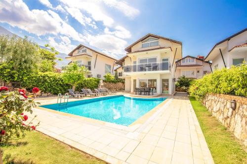 a swimming pool in front of a house at Villa Valley 5 in Oludeniz