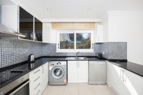 a kitchen with a sink and a washing machine at Villa Valley 5 in Oludeniz