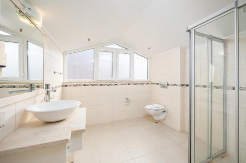 a bathroom with a glass shower and a toilet at Villa Valley 5 in Oludeniz