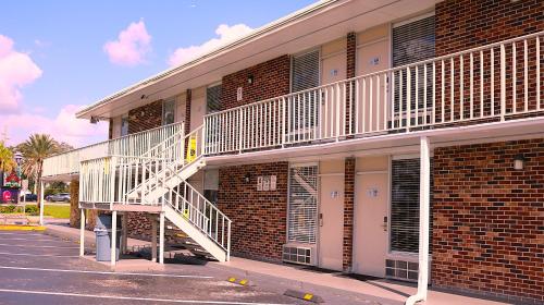 a brick building with a staircase on the side of it at Magic Key - Near Disney in Kissimmee