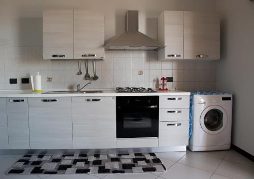 a kitchen with a stove and a washing machine at B&B Villa Virginia in Licata