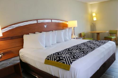 a bedroom with a large bed with a wooden headboard at Magic Key - Near Disney in Kissimmee
