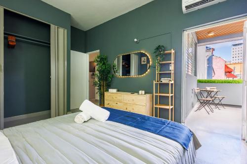 a bedroom with a large bed and a mirror at Spanish Lagoon San Juan with Private Patio by PH in San Juan
