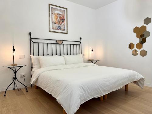 a bedroom with a large bed with white sheets at Suite with Private Courtyard - Colosseum & Forum in Rome