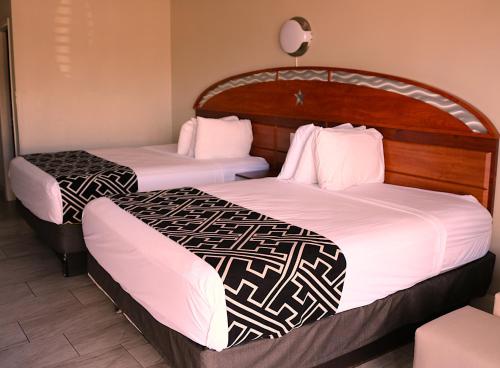a couple of beds in a hotel room at Magic Key - Near Disney in Kissimmee