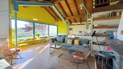 a living room with a blue couch and chairs at La Casa Amarilla de Cercedilla in Cercedilla