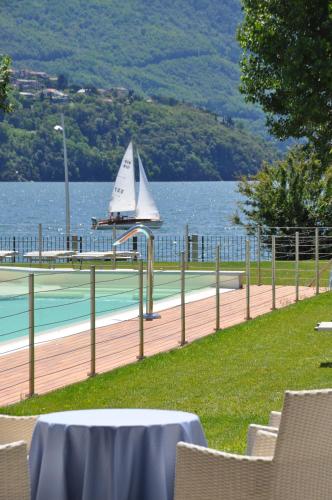 a sail boat on a tennis court next to the water at Tullio Hotel in Gravedona