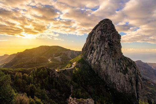 a mountain peak in the mountains at sunset at Banana Garden Suites in Hermigua