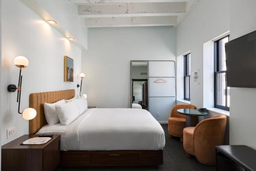 a hotel room with a bed and a desk at The Guild Hotel San Diego Downtown, a Marriott Tribute Portfolio Hotel in San Diego