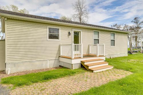 a house with a porch and stairs on it at Lake Champlain Family Retreat with Deck and Yard in North Hero