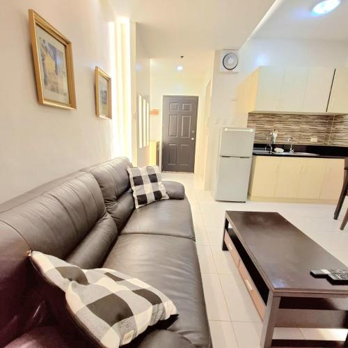 a living room with a couch and a coffee table at BREATHTAKING BAYVIEWS - 1-5 BR Luxury and Superior Condos with Panoramic Bay Views, Balcony, Gym, Pool & Netflix - Housekeeping Available - in Manila