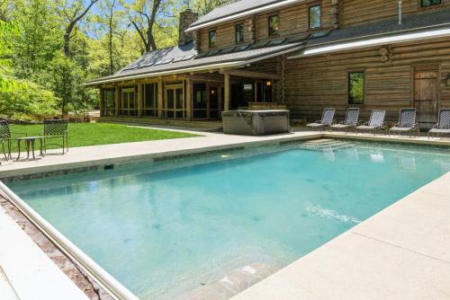 a large swimming pool in front of a house at Wilder Woods in Michiana