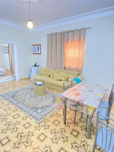 a living room with a couch and a table at نزل القمريه in Taif