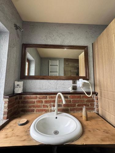 a bathroom with a sink and a mirror at Villa Nur Lakeview Dreams in Mavrovo