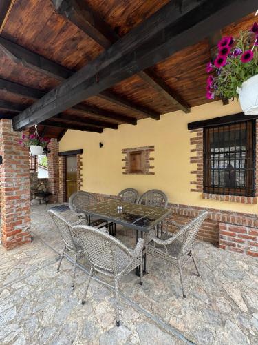 a patio with a table and chairs on a patio at Villa Nur Lakeview Dreams in Mavrovo