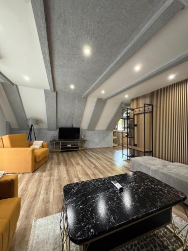 a living room with a couch and a table at Villa Nur Lakeview Dreams in Mavrovo