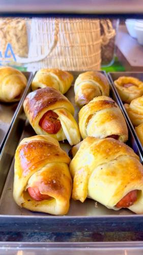 a tray filled with hot dogs and biscuits at Portal Da Praia Hotel in Fortaleza