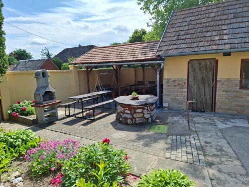 a patio with a table and a grill at Eszter Vendégház Harta in Harta