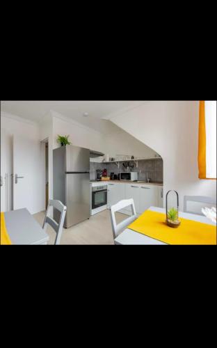 une cuisine avec une table et des chaises dans une pièce dans l'établissement Apparemment neuf entrée indépendante, à Hœrdt