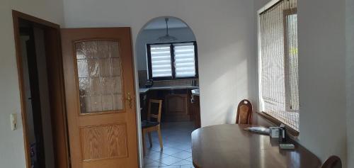 a room with a table and a window and a door at Ferienwohnung Hüttenholzstraße in Ilmenau
