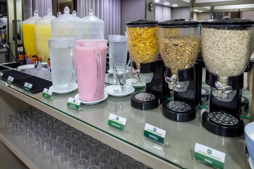 a counter with many different types of glass blenders at Hotel Nacional Inn Belo Horizonte in Belo Horizonte