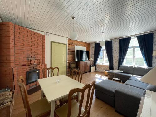 a living room with a couch and a table at Suur-Mere Guesthouse in Haapsalu