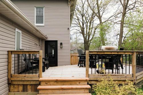 a wooden deck with a table and chairs on a house at SquirrelHaus PEC in Hillier