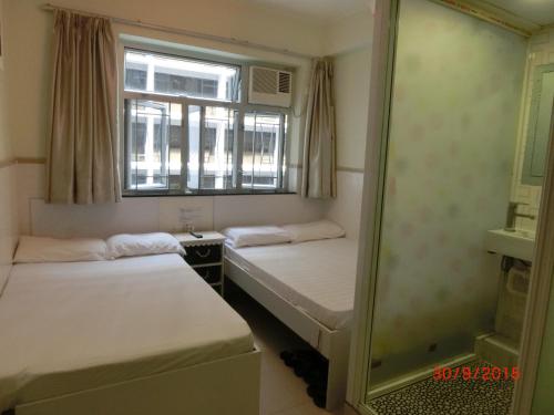 Llit o llits en una habitació de Li Cheng Guesthouse