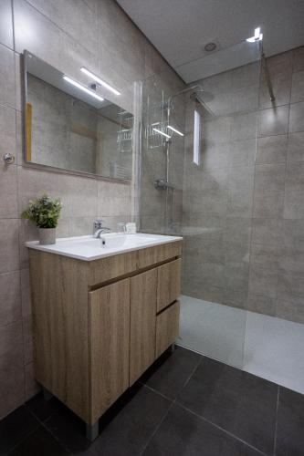 a bathroom with a sink and a shower at Casa Albelo do Gerês in Montalegre