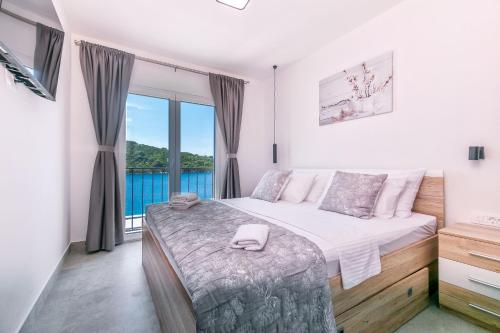 a bedroom with a bed and a large window at House Paval in Brnistrova
